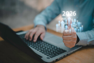 Businessman drawing digital growth arrows and bar graph with 2026 target. Futuristic concept for business goals, technology strategy, data-driven planning, success and innovation.
