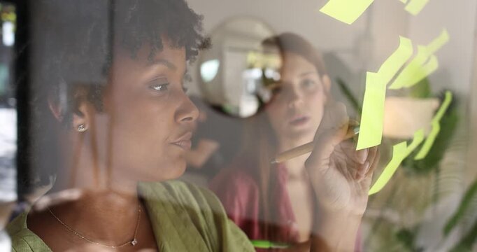 Diverse creative team brainstorming with sticky notes