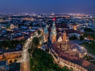 Aerial evening view of Wawel Castle in Krak&oacute;w (Cracow), Poland, with illuminated walls and Vistula River