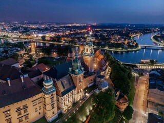 Aerial evening view of Wawel Castle in Krak&oacute;w (Cracow), Poland, with illuminated walls and Vistula River