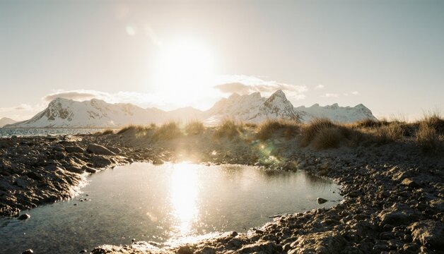 Golden sunlight reflects on a tranquil pond near snowy mountains at dawn Generative AI