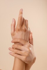 Hands with vitiligo skin condition on neutral background 
