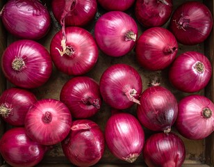 Top view of red onions arranged closely on a tray, highlighting rich color, natural texture, and fresh, rustic food presentation.
