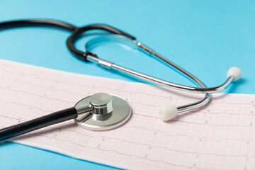 Medical stethoscope, red heart, and cardiogram on a color background. ECG, Heart wave, heart attack, cardiogram report. Cardiogram pulse trace and heart concept. Healthcare.Space for text