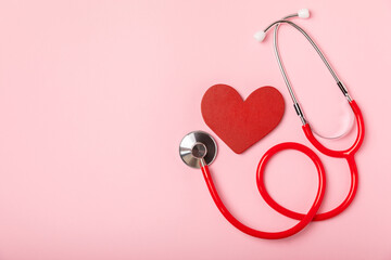 Medical stethoscope, red heart, and cardiogram on a color background. ECG, Heart wave, heart attack, cardiogram report. Cardiogram pulse trace and heart concept. Healthcare.Space for text