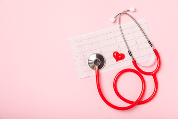 Medical stethoscope, red heart, and cardiogram on a color background. ECG, Heart wave, heart attack, cardiogram report. Cardiogram pulse trace and heart concept. Healthcare.Space for text
