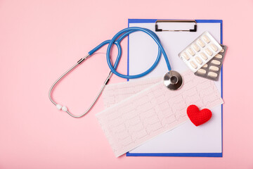 Medical stethoscope, red heart, and cardiogram on a color background. ECG, Heart wave, heart attack, cardiogram report. Cardiogram pulse trace and heart concept. Healthcare.Space for text