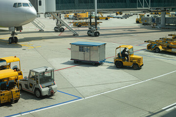 Multiple aircraft pushback tractors and ground support vehicles parked on the tarmac at an airport, ready for aircraft towing and ground operations.