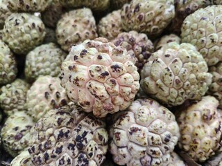Close up shot of pile of fresh custard apple or sarifa open sell in Indian market.