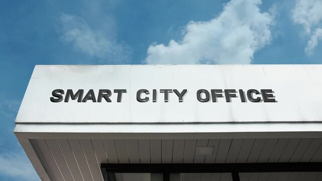 Smart City Office word sign displayed on governmental or corporate building under a clear blue sky, symbolizing urban technology, digital governance, innovation, sustainability, data management