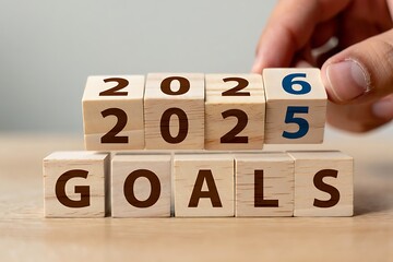 Setting goals for 2026 concept with wooden blocks and hand
