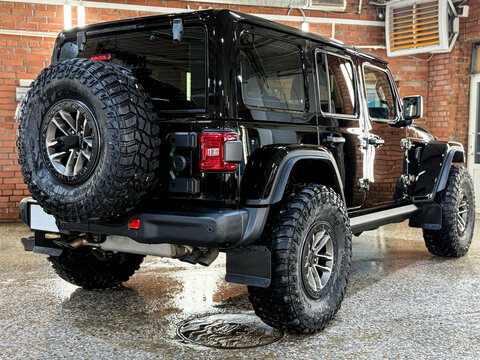 Jeep Wrangler Rubicon four-door pickup 4x4 black color in showroom. Exterior Jeep Rubicon Wrangler four-door pickup truck American off-road us vehicle. American SUV.