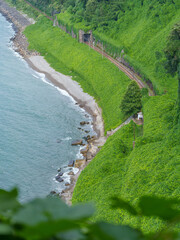 Coastal Railway Line Curving Through Green Hills and Tunnel