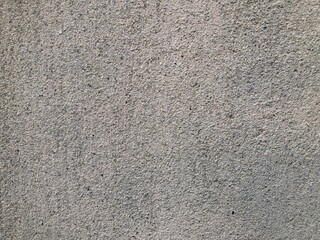 Rough grey concrete wall texture with speckled sand grain finish