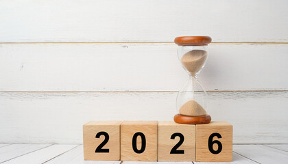 Hourglass on Top of 2026 Wooden Blocks Representing Time Passing and Planning for the Future