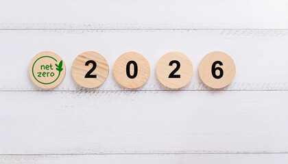 Green Net Zero Symbol on Wooden Circular Discs Displaying the Year 2026