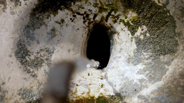 Roman street fountain seen from above with running water