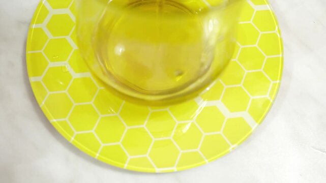 Adding olive oil to the bowl on a scale to get the right quantity for the recipe