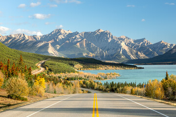 Autumn road to turquoise lake and mountains in Alberta, Canada