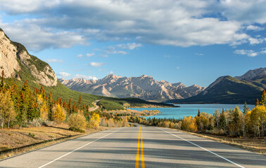 Autumn road to turquoise lake and mountains in Alberta, Canada