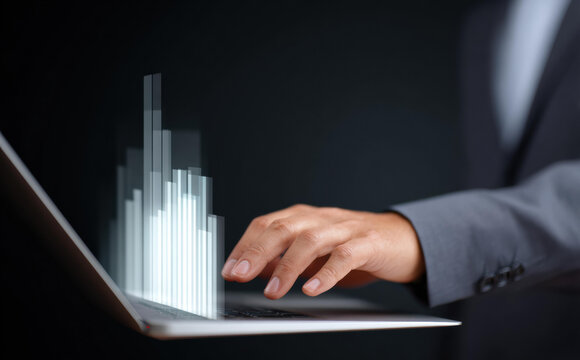 Focused businessman using laptop for business technology and finance data analysis. glowing chart symbolizes investment, success, and future corporate growth