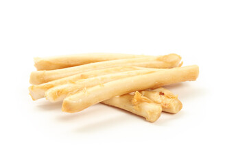 Dog chew sticks without rawhide. Rawhide alternative for dog and cat dental health and enrichment treat. Pile of rolled sticks made of chicken. Selective focus. White background.