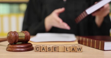 Exploring the world of legal knowledge with books and a gavel in a courtroom setting during the day