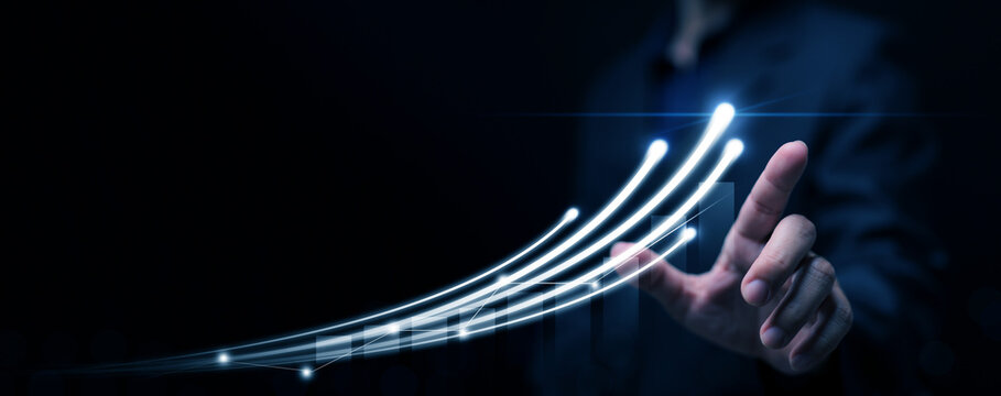 Businessman hand control glowing digital curve line with rising trend, symbolizing innovation, growth, success, data analytics, and growing business and technology.