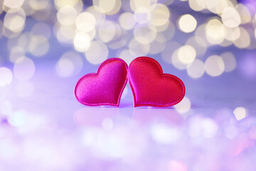 Fototapeta premium Two red hearts with golden bokeh lights. Romantic holiday background for Valentine’s Day, anniversary, wedding, or New Year greeting cards. Symbol of love, joy, and celebration.