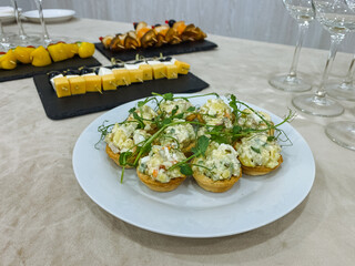 Herb topped tartlets on plate with creamy filling, dill and arugula garnish, golden pastry shells, chef crafted appetizer perfect for tasting menu, intimate tasting moment, delicate