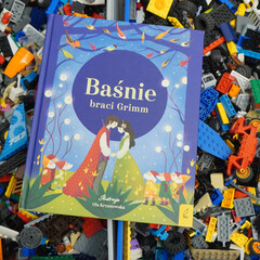 Obraz premium Polish edition of Grimm's Fairy Tales with colorful illustrations on a background of toy blocks