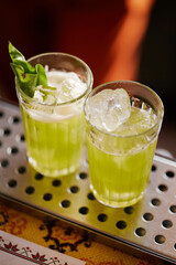 Making atmospheric rustic cocktails in faceted glasses