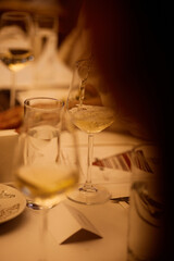 A waiter pours wine in a restaurant in the evening