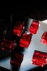 Red jelly on a mirrored metal tray