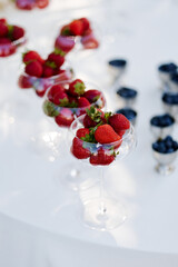 Fresh berries in the bright sun on the dessert table