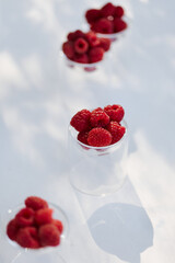 Fresh berries in the bright sun on the dessert table