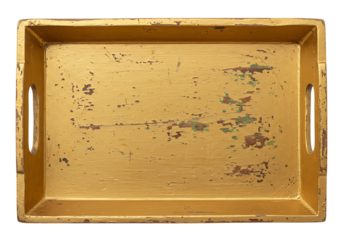 A weathered gold serving tray with distinct signs of age and use showing its textured surface