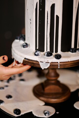 Black three-tiered cake with white cream