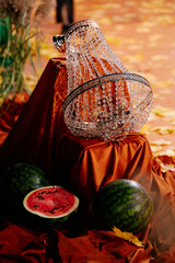 Holiday decorations with apricots, watermelons and medieval fabrics and chandeliers