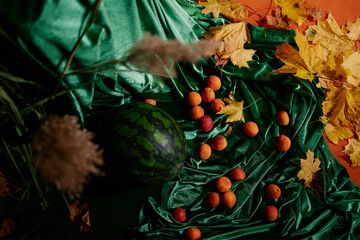 Holiday decorations with apricots, watermelons and medieval fabrics and chandeliers
