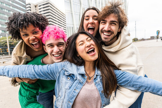 Multiracial friends taking selfie picture with smart mobile phone outside - Group of young people smiling at camera outdoors