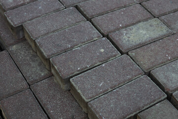 Paved surface made of weathered rectangular bricks arranged neatly on a construction site