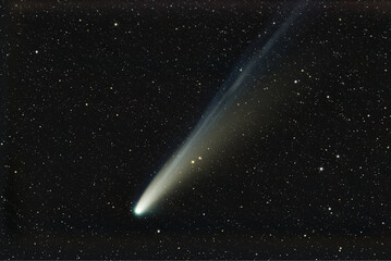 Beautiful comet with long glowing gas tail in outer space. © kochievmv