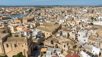 Aerial view of houses and buildings in the historic center of Mazara del Vallo, in the province of Trapani, Sicily, Italy. It's a beautiful sunny day.