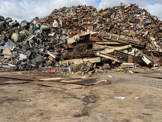 Large pile of scrap metal awaiting recycling in junkyard