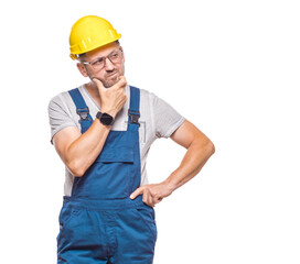Annoyed repairman looking to side, isolated on white background. Craftsman against white wall