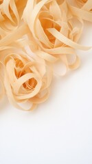 Fototapeta premium Soft wooden shavings create an inviting texture on a pure white background, perfect for artistic projects and creative designs