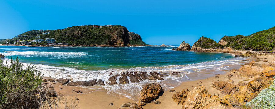 A panorama view past a beach towards the strait between East and West Head headlands, South Africa in Springtime
