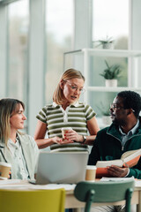 Diverse business team collaborating in informal office meeting
