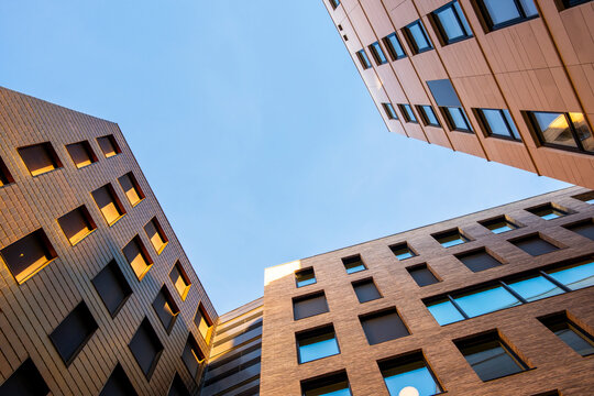 Upward architectural composition of modern city skyline featuring intersecting structure and facade geometry in symmetry, expressing perspective, balance and minimal urban atmosphere
